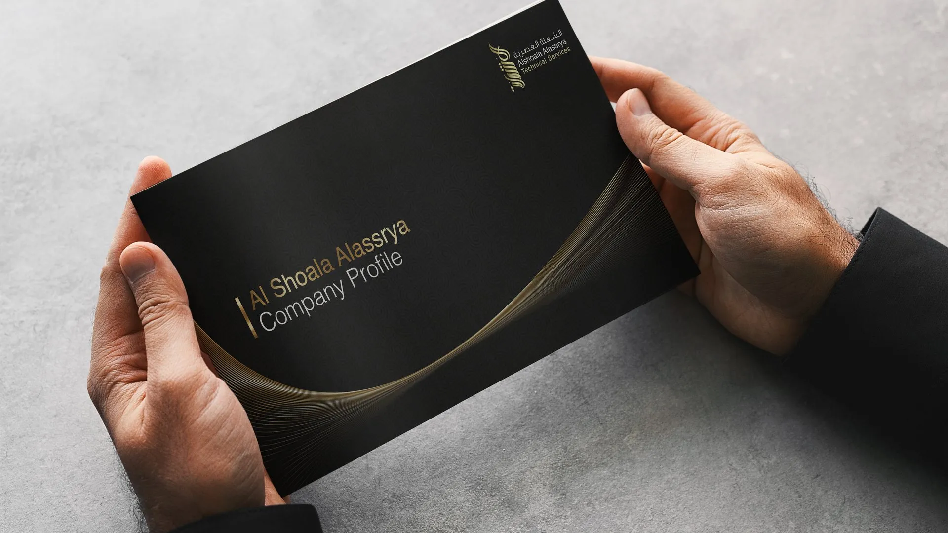 Alshoala Alassrya company profile held in two hands