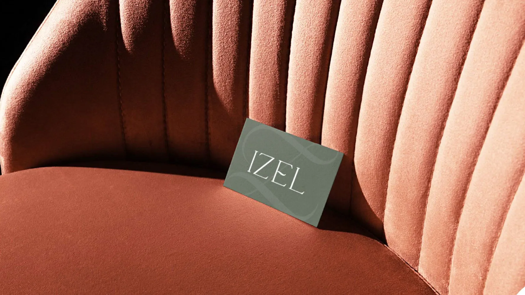 Izel business card resting on a velvet chair